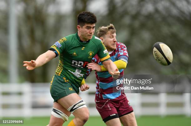 Sam Snell of Plymstock Albion Oaks offloads under pressure from Mark Wratten of OPMs during the Lockie Cup Semi Final match between Old Plymouthian...