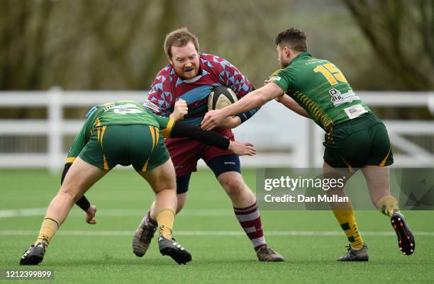 Ben Neville of OPMs is tackled by Alex Broughton and Hayden Coles of Plymstock Albion Oaks during the Lockie Cup Semi Final match between Old...