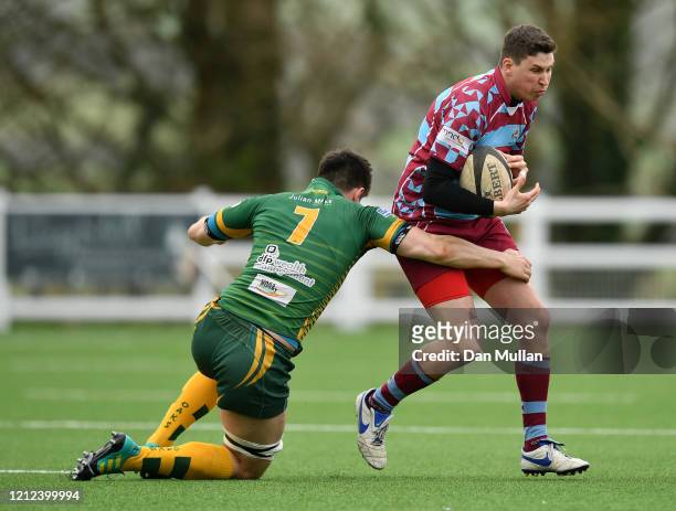 Peter Regan of OPMs is tackled by Sam Snell of Plymstock Albion Oaks during the Lockie Cup Semi Final match between Old Plymouthian and Mannameadians...