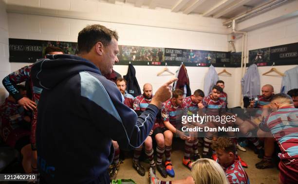 Rik Orkney, Head Coach of OPMs talks to his players in the changing room at half time during the Lockie Cup Semi Final match between Old Plymouthian...
