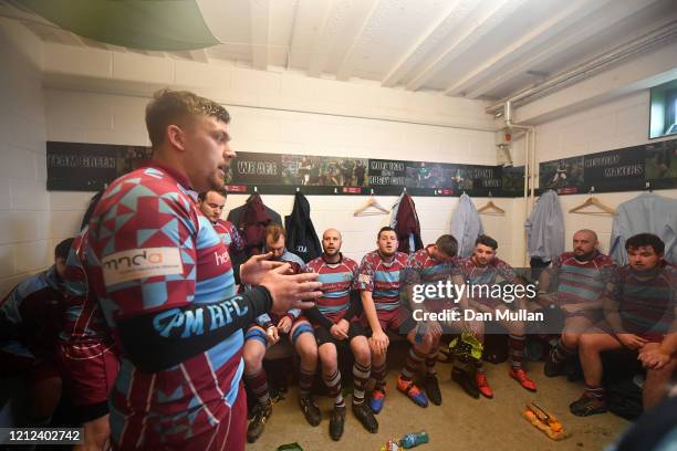 Billy Garratt of OPMs talks to his players in the changing room at half time during the Lockie Cup Semi Final match between Old Plymouthian and...