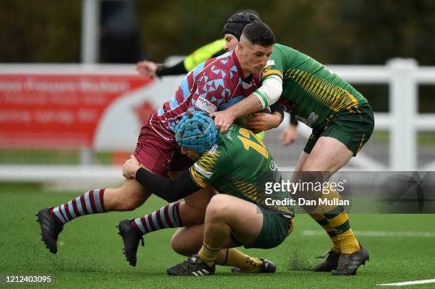 Aaron Stapleton of OPMs is tackled by Alex Broughton and Tom Richards of Plymstock Albion Oaks during the Lockie Cup Semi Final match between Old...