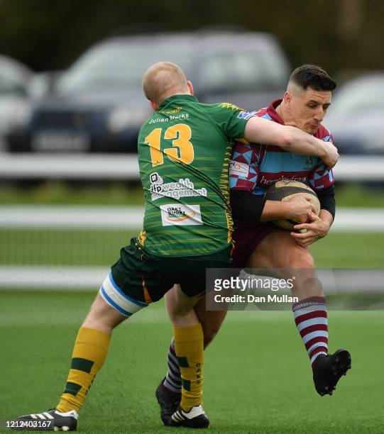 Aaron Stapleton of OPMs is tackled by Huw Moorcraft of Plymstock Albion Oaks during the Lockie Cup Semi Final match between Old Plymouthian and...