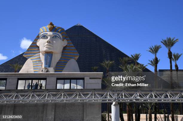 Visitors wait for a tram in front of Luxor Hotel and Casino as the coronavirus continues to spread across the United States on March 14, 2020 in Las...
