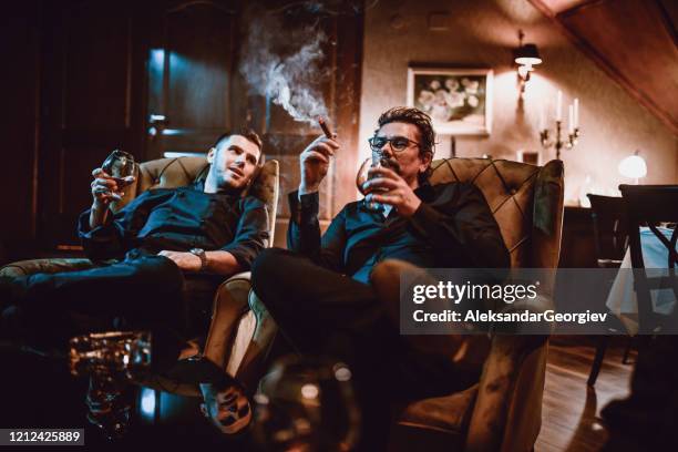 黑手黨家庭父親和兒子享受好白蘭地與雪茄和談話 - cognac 個照片及圖片檔