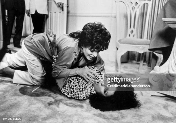 Actresses Joan Collins and Diahann Carroll in a rough fight scene on the set of TV series Dynasty in Hollywood, California in May 1986. .