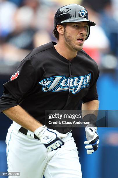 Arencibia of the Toronto Blue Jays tries to run out a hit in a MLB game against the Los Angeles Angels of Anaheim on August 14, 2011 at the Rogers...