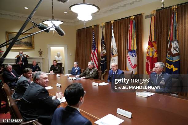 President Donald Trump flanked by Chairman of the Joint Chiefs of Staff General Mark Milley and Vice Chairman of the Joint Chiefs of Staff General...