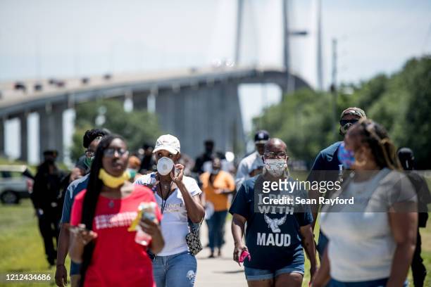 People return to their vehicles after gathering to honor the life of Ahmaud Arbery at Sidney Lanier Park on May 9, 2020 in Brunswick, Georgia. Arbery...