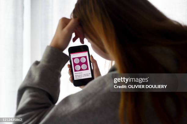 In this photo illustration, a person looks at an Abortion Pill for unintended pregnancy from Mifepristone displayed on a smartphone on May 8 in...