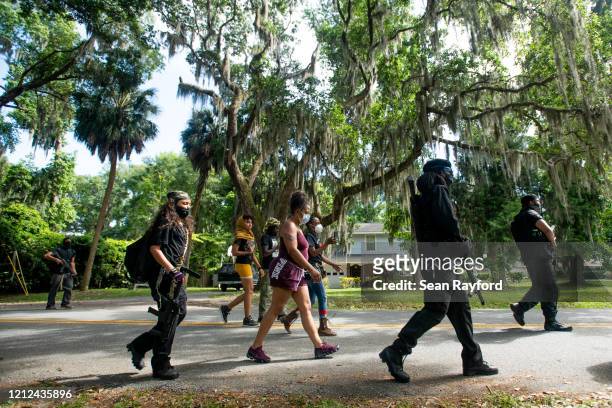 Members of the Black Panther Party, "I Fight For My People", and "My Vote is Hip Hop" demonstrate in the Satilla Shores neighborhood on May 9, 2020...