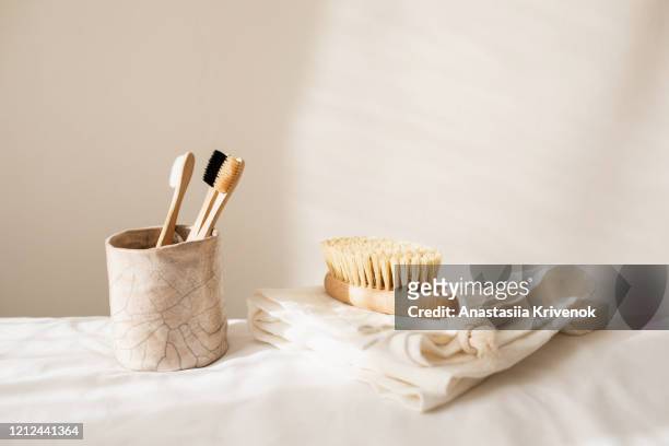 collection of assorted kitchen and bathroom tools, organic sponges and brushes, natural soap, wood toothbrushes, linen napkin and other ecological products on beige background. set of zero waste cleaning products. eco friendly concept - cosmetics counter stock pictures, royalty-free photos & images