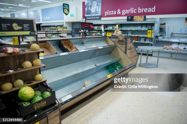 Consumers leave shelves empty in a London Morrisons store as panic-buying over coronavirus continues on March 14, 2020 in London England. Members of...