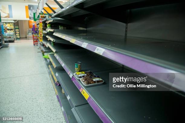 Consumers leave shelves empty in a London Morrisons store as panic-buying over coronavirus continues on March 14, 2020 in London England. Members of...