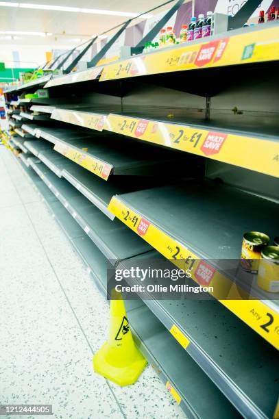 Consumers leave shelves empty in a London Morrisons store as panic-buying over coronavirus continues on March 14, 2020 in London England. Members of...