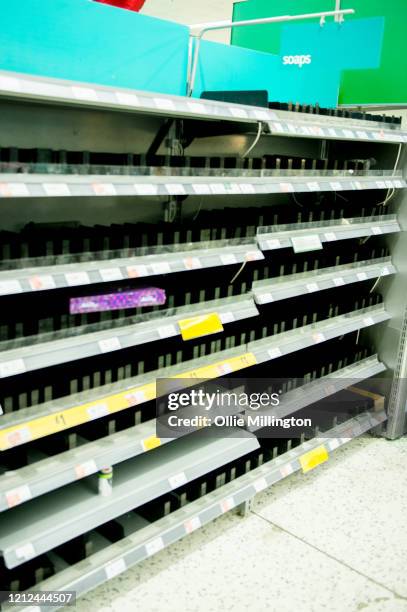 Consumers leave shelves empty in a London Morrisons store as panic-buying over coronavirus continues on March 14, 2020 in London England. Members of...