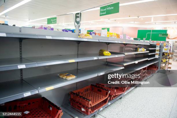 Consumers leave shelves empty in a London Morrisons store as panic-buying over coronavirus continues on March 14, 2020 in London England. Members of...