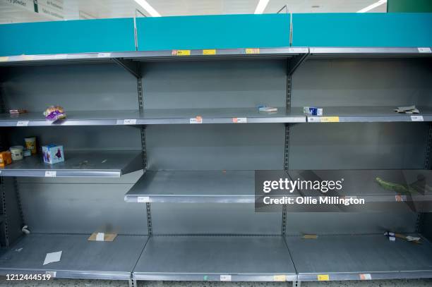 Consumers leave shelves empty in a London Morrisons store as panic-buying over coronavirus continues on March 14, 2020 in London England. Members of...