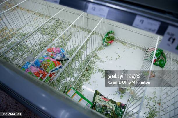 Consumers leave shelves empty in a London Morrisons store as panic-buying over coronavirus continues on March 14, 2020 in London England. Members of...