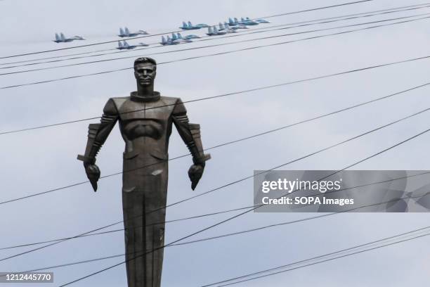 Russian Air Force Sukhoi Su-34, Su-30 and Su-35 jet aircraft fly in formation behind the monument to the first man in space Yury Gagarin during...