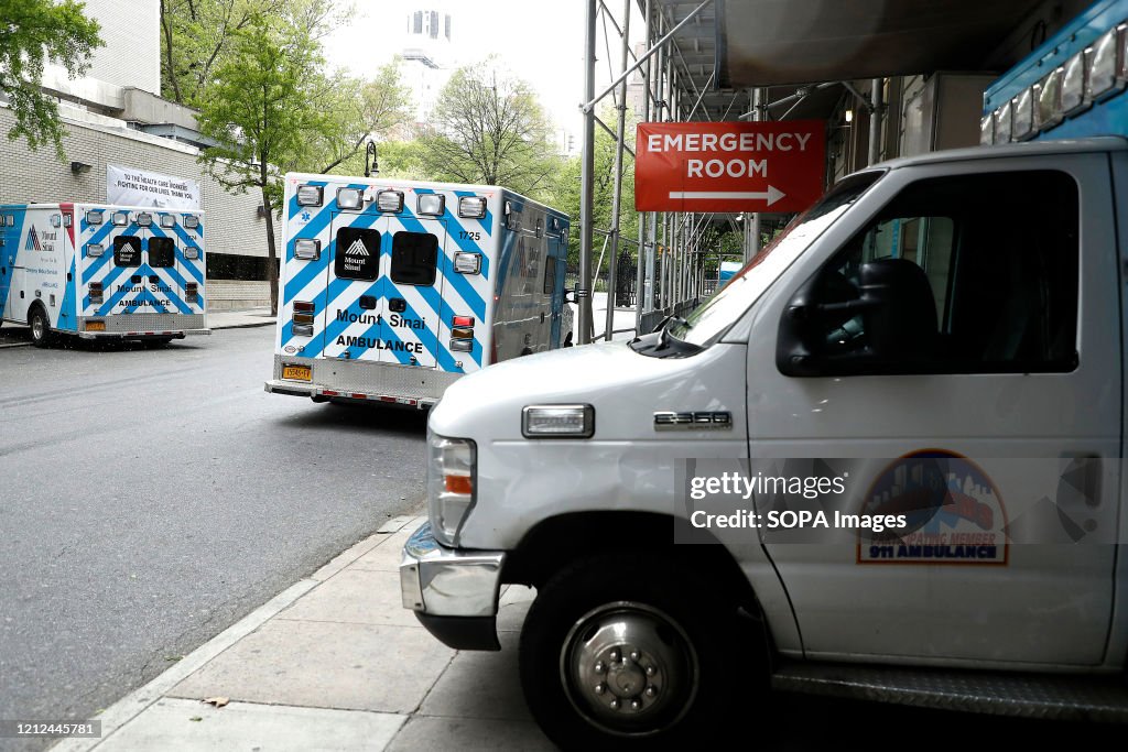 Ambulances are parked in front of the emergency entrance to...
