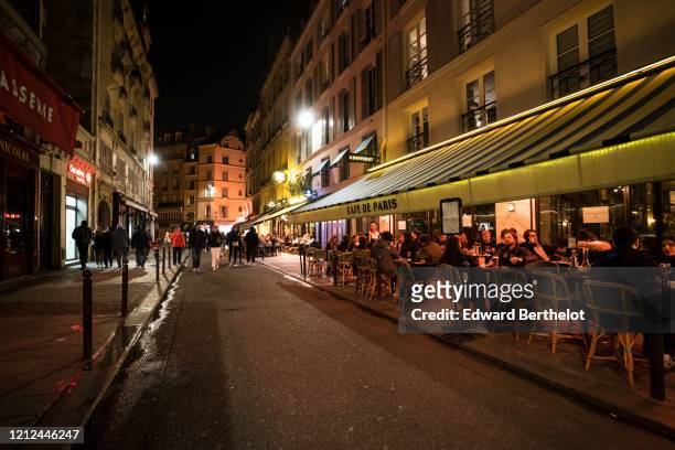 People gather at cafe "Cafe de Paris", in the 6th quarter of Paris, after French Prime Minister Edward Philippe announced that France will shut...