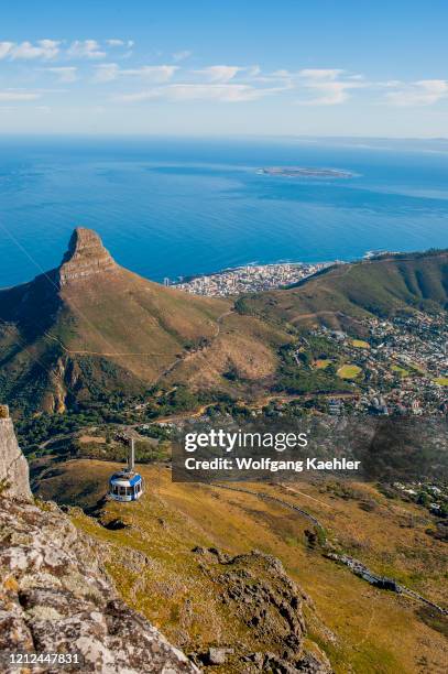 View of the cable car and Lions Head mountain from the top of Table Mountain in Cape Town, South Africa.