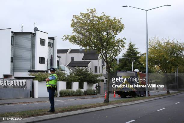 Police officer stands guard along Riccarton Road outside the Masjid An-Nur mosque on March 15, 2020 in Christchurch, New Zealand. 51 people were...