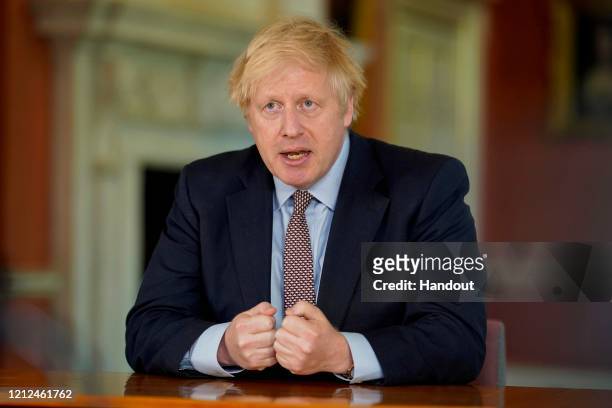 In this handout image provided by No 10 Downing Street, Britain's Prime Minister Boris Johnson records a televised message to the nation released on...