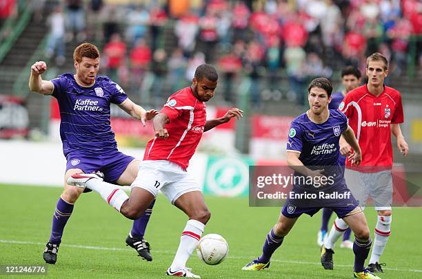 Phil Ofosu-Ayeh of Rot Weiss Erfurt battles for the ball with Niels Hansen and Andreas Glockner of VFL Osnabrueck during the Third League match...