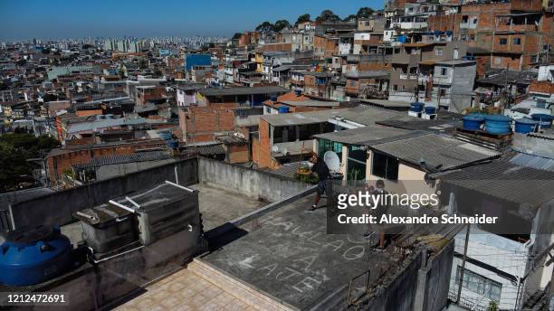 Ivan Pereira do Nascimento, 39 years old, conducts training sessions from the roof of his house to residents of Brasilandia amidst the coronavirus...