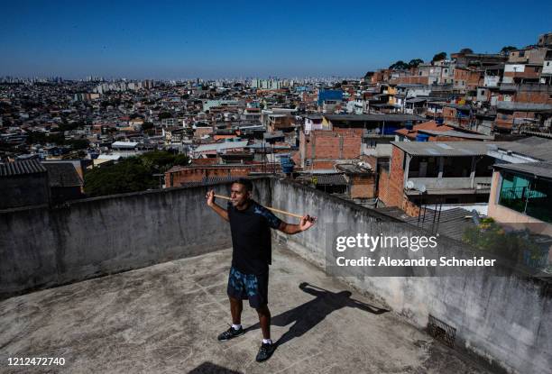 Ivan Pereira do Nascimento, 39 years old, conducts training sessions from the roof of his house to residents of Brasilandia amidst the coronavirus...