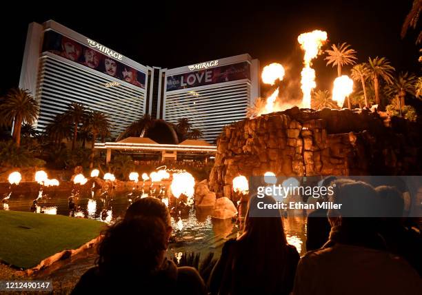 Building wraps for “The Beatles LOVE by Cirque du Soleil” show are shown on the exterior of The Mirage Hotel & Casino as visitors watch the resort's...