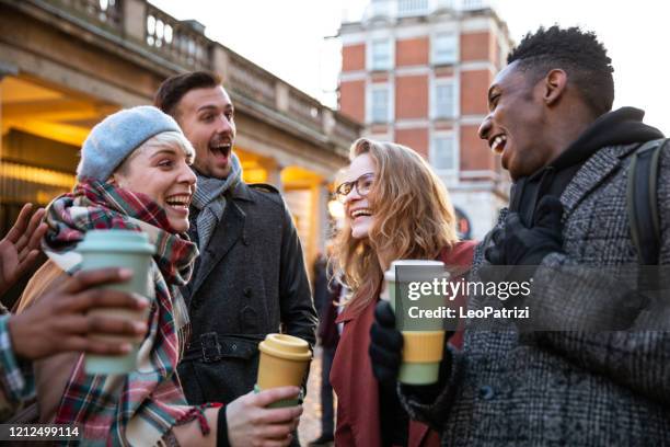 friends enjoying a cup of coffee with reusable travel mugs - covent garden stock pictures, royalty-free photos & images