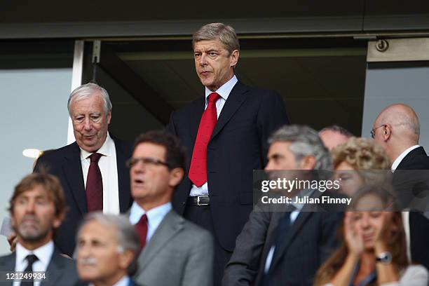 Arsenal manager Arsene Wenger looks on from the stands as he serves a one match touchline ban ahead of the UEFA Champions League play-off first leg...