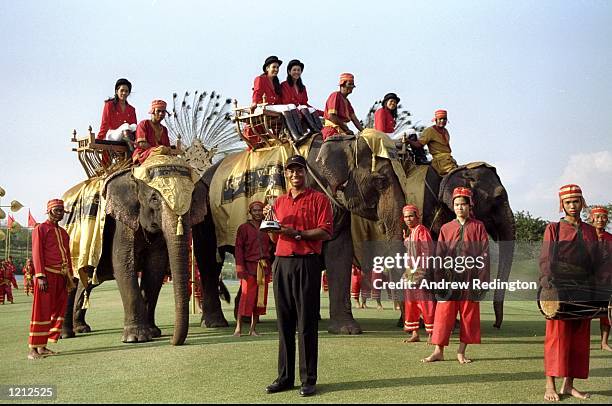 Tiger Woods of the USA holds the Johnnie Walker Classic trophy in front of the locals after winning the event played at Blue Canyon GC, Thailand. \...