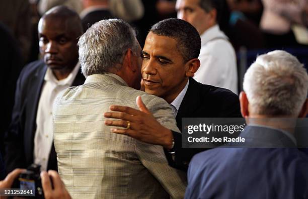 President Barack Obama is hugged after speaking during the opening session of the Rural Economic Forum at Northeast Iowa Community College on August...