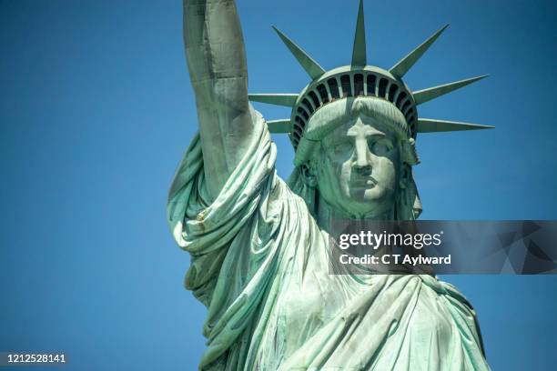 the statue of liberty on a sunny day - statue of liberty foto e immagini stock