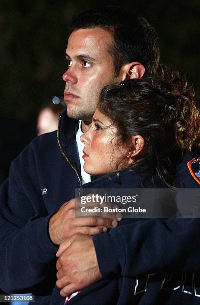 Jamie Privitar, a firefighter from N.Y. Who lost co-workers and friends during the Sept. 11 attack, and his girlfriend Jaide Wesley, watch the at the...