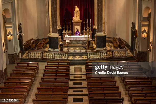 Priest Carlos Enrique Leal holds Mass as it is live-streamed via Youtube to its parishioners, at an empty Santa Maria de Betlem church on March 15,...