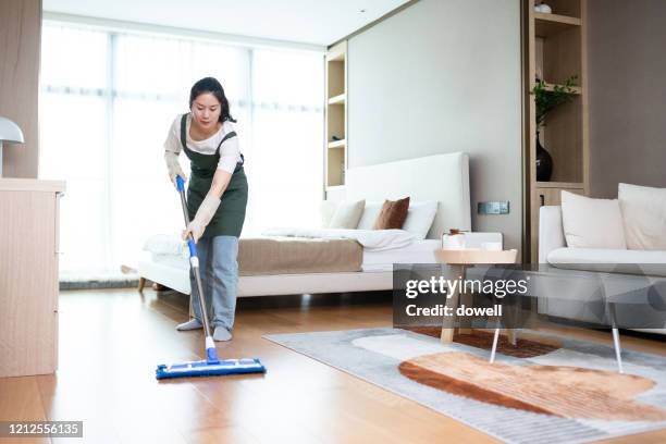 woman cleaning floor house with mop - woman sweeping stock pictures, royalty-free photos & images