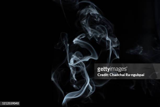 white smoke with black background smoke. smoke concept. - incense stock-fotos und bilder
