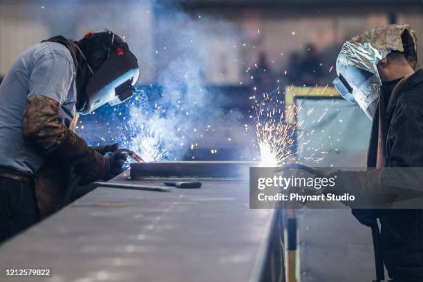 welders working in workshop, - sheet metal stock pictures, royalty-free photos & images