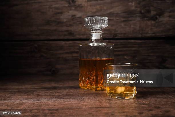 whiskey or bourbon with ice on a wood background - cognac brandy stock pictures, royalty-free photos & images