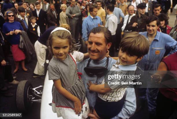 Graham Hill British racing driver and team owner, after winning the 1965 Monaco Grand Prix with his children Brigitte and Damon, May 30, 1965.