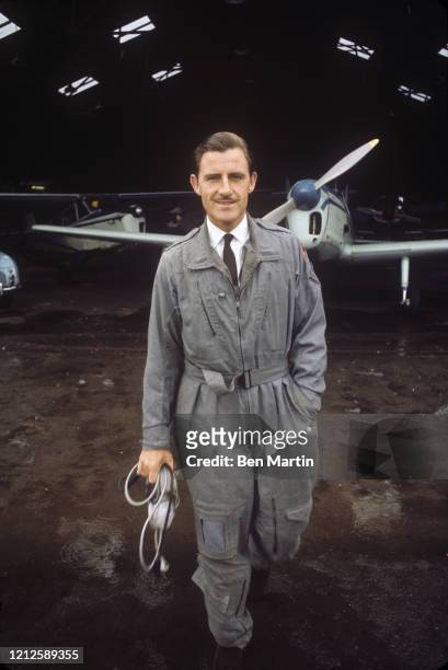 Graham Hill British racing driver and team owner, Formula One World Champion twice, in hangar with his airplane, 1965.