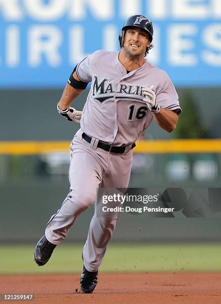 Bryan Petersen of the Florida Marlins heads for third base as he triples off of starting pitcher Jhoulys Chacin of the Colorado Rockies in the first...