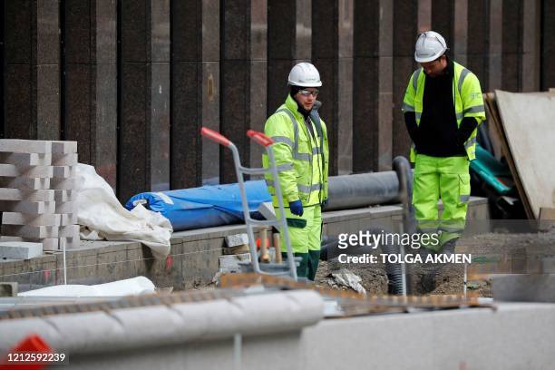 Workers in a hard hats work on a building construction site in central London on May 11 as life in Britain continues during the nationwide lockdown...