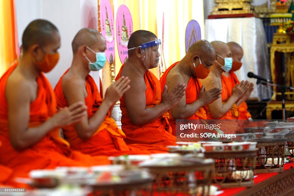 Buddhist monks wearing face masks as a preventive measure...