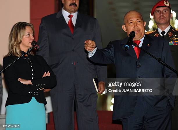 Venezuelan President Hugo Chavez speaks next to the South American Union of Nations Secretary General, Colombian Maria Emma Mejia, after a meeting in...